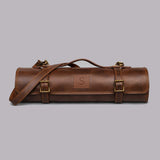 Brown full grain cow leather chef knife roll holding 6 knives with shoulder strap and zipper pocket