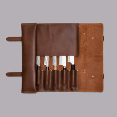 Brown full grain cow leather chef knife roll holding 6 knives with shoulder strap and zipper pocket