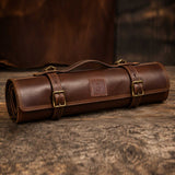 Brown full grain cow leather chef knife roll holding 6 knives with shoulder strap and zipper pocket