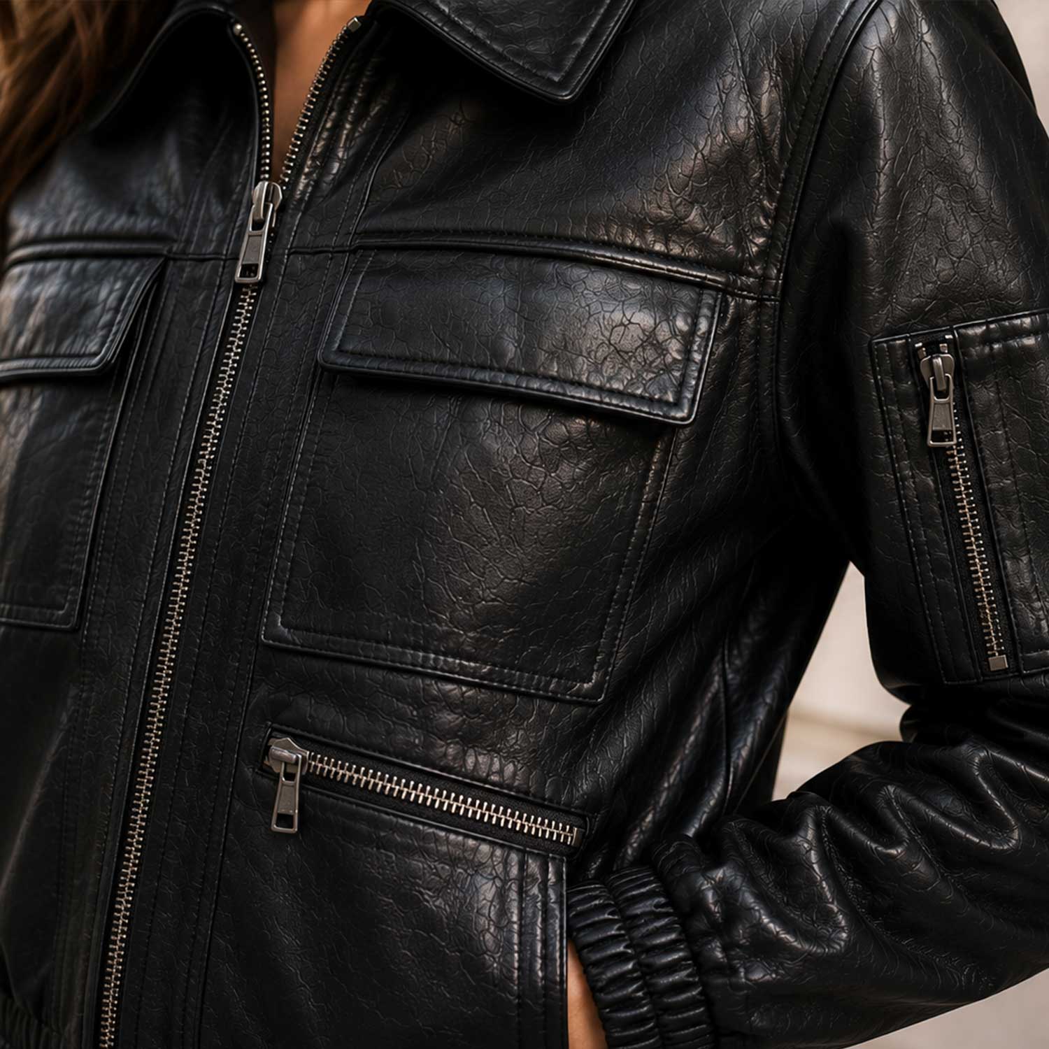 Close-up of premium black sheepskin leather grain on The Corvayne bomber jacket.