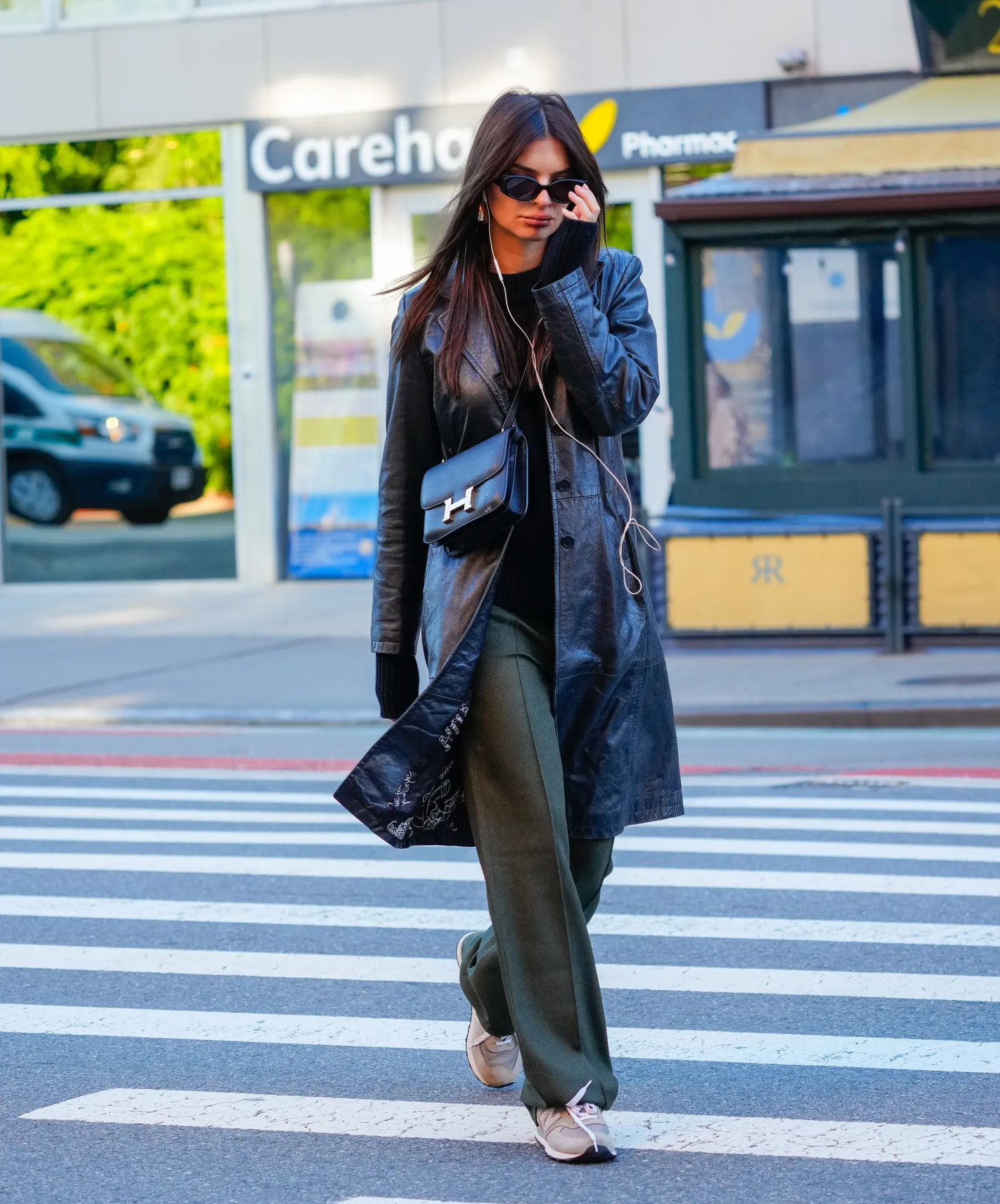 Emily Ratajkowski layering a leather trench over a black turtleneck in Gotham